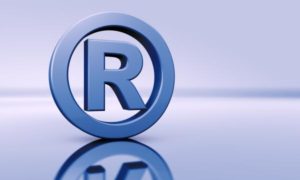 Trademark Lawyer Bakersfield, CA R in a circle for trademark registration